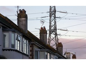 An electricity transmission pylon above residential houses in Brighton, U.K., on Thursday, Nov. 12, 2020. Brexit talks are going down to the wire, and the European Union's chief negotiator Michel Barnier is threatening British access to the continent's single energy market as a way of extracting concessions on fishing rights. Photographer: Chris Ratcliffe/Bloomberg