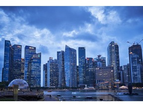 Buildings are illuminated at dusk in the central business district (CBD) of Singapore, on Thursday, Jan. 28, 2021. HSBC Holdings Plc plans to accelerate its expansion across Asia in its imminent strategy refresh, Chairman Mark Tucker told the virtual Asian Financial Forum last week. Photographer: Lauryn Ishak/Bloomberg