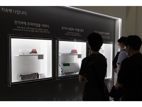 Attendees look at LG Energy Solution Co. battery cells and modules for electric vehicle (EV) at the InterBattery 2021 in Seoul, South Korea, on Wednesday, June 9, 2021. Global electric-vehicle battery sales more than doubled in the first four months of the year as the switch to environmentally-friendly cars gathers pace.