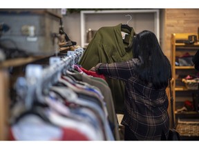 A shopper browses clothing for sale inside a Hospice Thrift Shoppe in Walnut Creek, California. Photographer: David Paul Morris/Bloomberg