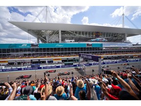 Fans wave during the start of the Sunday race at the Miami International Autodrome on May 8, 2022. The Sunday race climaxes a week of parties, previews, opening events and qualifying rounds.  Photographer: Alex Bierens de Haan/Getty Images Europe