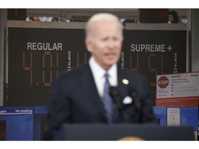 President Biden speaks in front of a monitor with fuel prices. Photographer: Samuel Corum/Bloomberg