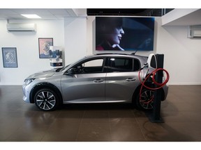 A Peugeot e-208 electric vehicle charging in a Peugeot and DS showroom, operated by Stellantis NV, in Paris, France, on Thursday, July 28, 2022. Stellantis expects to overcome supply-chain snarls to extend strong earnings into the second half of the year as the maker of Jeeps and Fiats focuses production on its most profitable models.