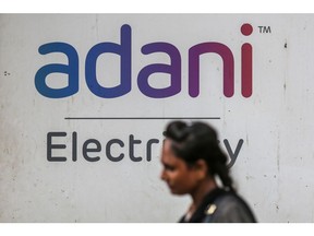 Signage of Adani Electricity Mumbai Ltd., of Adani Group in Mumbai, India, on Tuesday, Sep. 6, 2022. Adani Group, indirectly acquired a 29.2% stake in New Delhi Television Ltd., or NDTV, and offered to buy another 26% from the open market for a combined 6.07 billion rupees ($76 million) in August 2022.