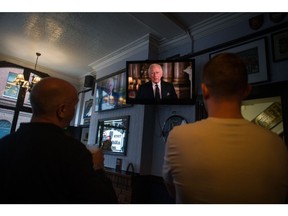 Customers watch the first broadcast by King Charles III to the nation and commonwealth on the first day of public mourning, following the death of Queen Elizabeth II, at the King and Queen pub in London, UK, on Friday, Sept. 9, 2022. Elizabeth II's death at the age of 96 marks the start of a tumultuous 10 days for the UK that will see a queen buried, a nation mourn its longest-reigning monarch, and a new king proclaimed. Photographer: Nathan Laine/Bloomberg