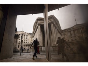 Morning commuters pass the Bank of England (BOE), left, and The Royal Exchange, in the City of London, UK, on Monday, Oct. 17, 2022. The Bank of England said it was restarting its corporate bond-selling as it looks to return to normality in the wake of a sustained selloff in UK assets. Photographer: Jason Alden/Bloomberg
