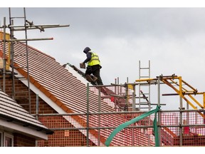 An employee fixes tiles to the roof of a home at a Taylor Wimpey Plc residential housing construction site in Hoo, UK, on Monday, Jan. 9, 20233. Taylor Wimpey is due to give a trading update on Friday.