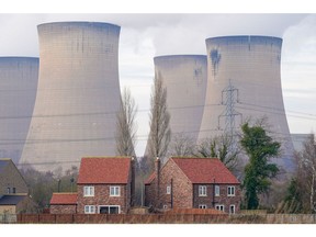 Residential housing near cooling towers at Drax Power Station, operated by Drax Group Plc, where coal-fired units 5 and 6 have been put on standby to generate electricity supplies during a cold snap, near Selby, UK, on Monday, Jan. 23, 2023. Drax Power station is one of three stations that negotiated a winter contingency contract with National Grid Plc for this winter following a request from the government.