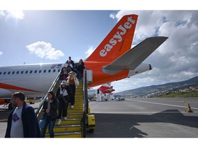 Passengers disembark an EasyJet Plc passenger airport at Madeira Airport, operated by ANA Aeroportos de Portugal SA, in Funchal, Portugal, on Sunday, Feb. 5, 2023. For Portugal, which has the third-highest debt ratio in the euro area behind Greece and Italy, tourism represents about 15% of the economy. Photographer: Zed Jameson/Bloomberg