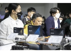 Visitors look at Samsung SDI Co.'s PRiMX batteries at the InterBattery exhibition in Seoul, South Korea, on Thursday, March 16, 2023. The exhibition will run through March 17.