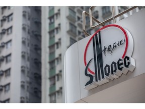 The logo for China Petroleum & Chemical Corp. (Sinopec) at a gas station in Hong Kong, China, on Saturday, March 25, 2023. Sinopec earnings fell last year as Covid restrictions pinched fuel demand, while domestic output of oil and gas rose to a record level. Photographer: Paul Yeung/Bloomberg