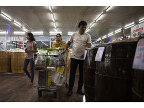 People shop at a supermarket in Lahore, Pakistan, on March 30, 2023. Rising inflation and tax hikes implemented to fulfill aid terms from the International Monetary Fund are eroding consumer purchasing power, according to Bloomberg Economics.