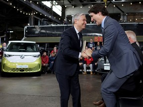 Prime Minister Justin Trudeau and Minister of Innovation, Science and Industry Francois-Philippe Champagne react during a news conference to announce details on the construction of a gigafactory for electric vehicle battery production by Volkswagen Group's battery company PowerCo SE in St. Thomas, Ontario on April 21.