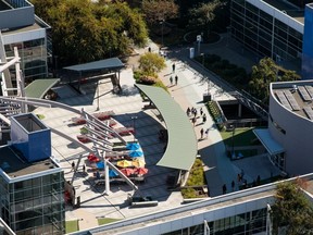 People walk through the Googleplex corporate headquarters building in this aerial photograph taken above Mountain View, Calif.