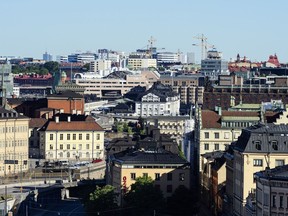 Old and new commercial and residential buildings stand on the city skyline in Stockholm, Sweden.