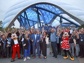 Mickey, Minnie and cast members join Walt Disney World executives in a ceremony marking the official opening of Tron Lightcycle / Run at the Magic Kingdom in Lake Buena Vista, Fla., on Monday, April 3, 2023. The roller coaster opens to guests on Tuesday. From left are Mickey Mouse; Ali Manion, Walt Disney World ambassador; Perry Crawley, Magic Kingdom operations general manager; Melissa Valiquette, vice president of Magic Kingdom; Jason Kirk, senior vice president of operations for Walt Disney World, Minnie Mouse.