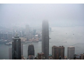 Buildings shrouded in fog in Hong Kong, China, on Monday, Feb. 6, 2023. The border between Hong Kong and China fully reopened marks a step in Hong Kong's bid to rebuild its reputation as a business hub connecting mainland China and the rest of the world, and comes days after Chief Executive John Lee unveiled a publicity campaign to revive the economy and welcome back visitors. Photographer: Lam Yik/Bloomberg