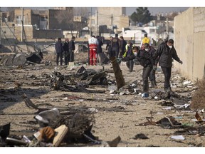 Officials work at the Ukrainian flight PS752 International airlines crash site, after the flight was shot down near Tehran, Iran, on Jan. 8, 2020. Photographer: Morteza Nikoubazi/NurPhoto/Getty Images