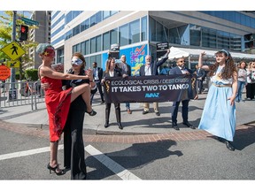 Two Avaaz dancers impersonate China and IMF Managing Director, Kristalina Georgieva, while performing "El tango de la deuda", and a third dancer, representing Argentina, tries to be a part of the dance. Thus, Avaaz exemplifies the growing difficulty of developing countries in stabilizing their economies, which are increasingly affected by climate change on Wednesday, April 12, 2023, in Washington. (Joy Asico/AP Images for AVAAZ)