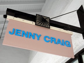 A Jenny Craig sign hangs outside a store in Miami, Fla.
