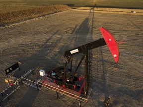 A pumpjack draws out oil and gas from a wellhead as the sun sets near Calgary, Alta., Sunday, Oct. 9, 2022. Industry experts say oil prices could return to US$100 a barrel later this year, giving a significant boost to Canada's energy sector.