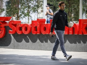 A pedestrian walks past a Scotiabank branch in downtown Calgary, Alta., Friday, Sept. 16, 2022.THE CANADIAN PRESS/Jeff McIntosh