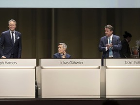 From left, Ralph Hamers, Chief Executive Officer of Swiss Bank UBS, gets a farewell applause from Lukas Gaehwiler, Vice Chairman of the Board of Directors and Colm Kelleher, Chairman of the Board of Directors during the general assembly of the UBS in Basel, Switzerland, Wednesday, April 5, 2023.