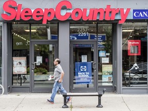 A man walks past a Sleep Country Holdings Inc. store on Queen Street East in Toronto’s Beaches area.