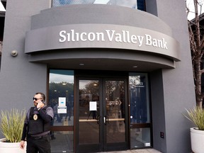 A security guard stands outside of the entrance of the Silicon Valley Bank headquarters in Santa Clara, California.