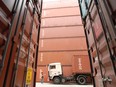 Triton International Ltd. containers being moved in Lau Fau Shan, Hong Kong, China.