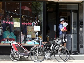 A man and his daughter enter a store on Bank Street in Ottawa.