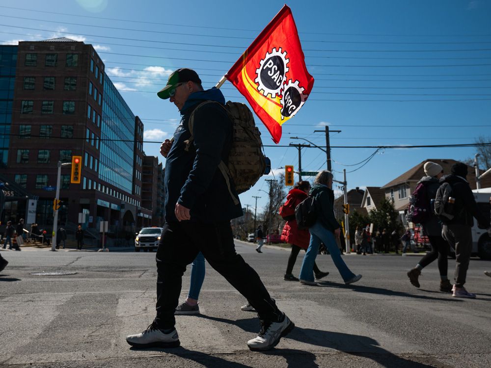 PSAC workers and supporters gather on a picket line in the Tuey