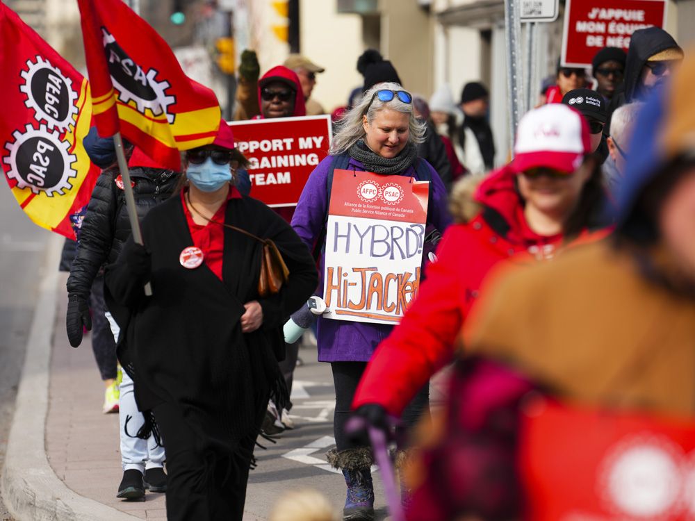PSAC workers and supporters picket in front of President of the Treasury Board Mona Fortier's office in Ottawa.