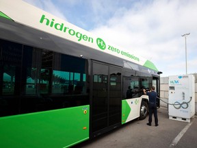 A driver fills the tank of an urban bus with green hydrogen.
