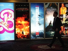 An attendee walks past advertisements for upcoming films on the opening day of CinemaCon 2023, the official convention of the National Association of Theatre Owners (NATO) at Caesars Palace, Monday, April 24, 2023, in Las Vegas. The four-day convention runs through Thursday.