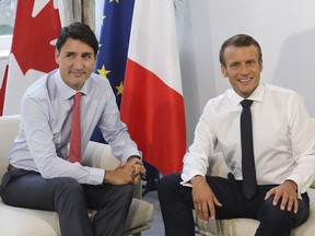 FILE - Canadian Prime Minister Justin Trudeau, left, poses with French President Emmanuel Macron during a bilateral meeting in Biarritz, southwestern France, Monday Aug. 26, 2019. Trudeau, Macron, and European Commission President Ursula von der Leyen will join business, political and philanthropic leaders, as well as celebrities, including Hugh Jackman and John Legend, for this year's edition of the Global Citizen NOW conference in New York City starting April 27, 2023.