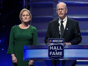 FILE - CEO and Chairman of NASCAR Jim France, right, along with the Executive Vice President of NASCAR Lesa France Kennedy announce the Landmark Award to Edsel Ford II at Hall of Fame induction ceremonies in Charlotte, N.C. Jan. 31, 2020. NASCAR teams boycotted a meeting with series leadership Wednesday as a show of frustration over the slow pace of negotiations on a new business model. Moving forward, they want NASCAR chairman Jim France and executive vice chair Lesa France Kennedy at the meetings, the team representatives told AP.
