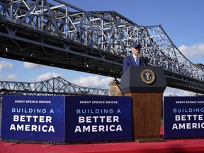FILE - President Joe Biden speaks about his infrastructure agenda under the Clay Wade Bailey Bridge, Wednesday, Jan. 4, 2023, in Covington, Ky. The Biden administration is closing out a three-week push to highlight the benefits of infrastructure investments in local communities by awarding nearly $300 million to help repair or replace more than a dozen bridges across the country. Events in four states on Thursday, April 13, will mark the end of the beginning of a more expansive White House push heading into Biden's expected 2024 reelection race to remind voters of his accomplishments.
