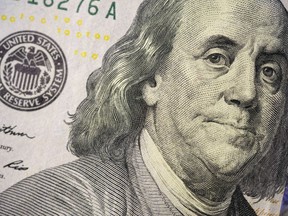 The likeness of Benjamin Franklin is seen on a U.S. $100 bill, Wednesday, Feb. 22, 2023, in Marple Township, Pa. In a time of high inflation and high interest rates, refunds for taxpayers are on average 10% smaller this year compared with last year, in part due to expired pandemic relief programs.