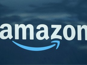 FILE - An Amazon logo appears on a delivery van, Oct. 1, 2020, in Boston. Amazon's total injury rate for warehouse workers took a dip last year, but injuries were still worse than they were in 2020, according to an analysis released Wednesday, April 12, 2023, by a coalition of labor unions.