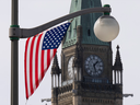 A U.S. flag flutters in front of the Peace Tower in Ottawa.