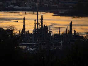 A boat travels past the Parkland Burnaby Refinery on Burrard Inlet at sunset in Burnaby, B.C., on Saturday, April 17, 2021. A U.S. activist investor says it will withhold support from all of Parkland Fuel Corp.'s incumbent directors at the company's upcoming annual meeting.