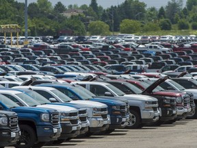 Vehicles are seen in a parking lot at the General Motors Oshawa Assembly Plant in Oshawa, Ont., on June 20, 2018. Statistics Canada says wholesale sales fell 1.7 per cent to $85.6 billion in February after hitting a record high in January.