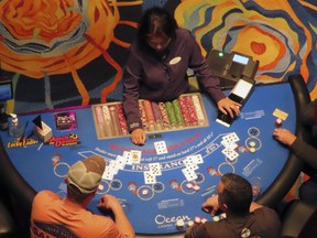 A dealer conducts a card game at the Ocean Casino Resort in Atlantic City, N.J., Dec. 2, 2022. Figures released April 10, 2023, by New Jersey gambling regulators show the city's nine casinos collectively posted a gross operating profit of $731 million in 2022, down 4.6% from the previous year.