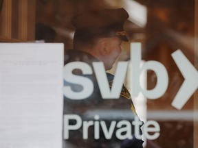 A police officer controls an access to a branch of Silicon Valley Bank in Wellesley, Massachusetts on March 13, 2023.