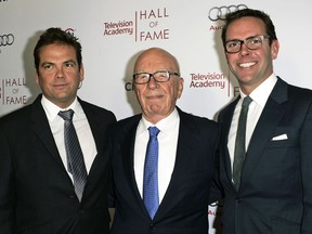 FILE - News Corp. Executive Chairman Rupert Murdoch, center, and his sons, Lachlan, left, and James Murdoch attend the 2014 Television Academy Hall of Fame in Beverly Hills, Calif., on March 11, 2014. Fox Corp. chief executive Lachlan Murdoch on Friday, April 21, 2023, dropped his defamation lawsuit against Australian news website Crikey, citing the Fox News settlement of a U.S. court case where the network agreed to pay almost $800 million over its lies involving the 2020 U.S. presidential election.