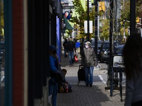People shop in the Glebe community of Ottawa on Thursday, Oct. 15, 2020. Small businesses in Canada have received less than 10 per cent of the financial aid they were promised to help them offset the costs of the national price on carbon emissions.