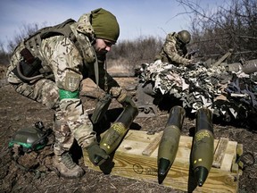A Ukrainian serviceman prepares a 105 shell to fire at Russian possitions near Bakhmut, on March 14 Photographer: Aris Messinis/AFP/Getty Images