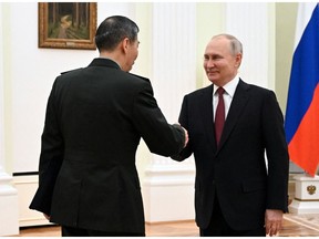 Vladimir Putin, right, meets Li Shangfu in Moscow on April 16. Photographer: Pavel Bednyakov/AFP/Getty Images