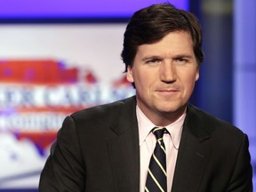 FILE - Tucker Carlson, host of "Tucker Carlson Tonight," poses for photos in a Fox News Channel studio on March 2, 2017, in New York. Fox News says it has agreed to part ways with Tucker Carlson, less than a week after settling a lawsuit over the network's 2020 election reporting. The network said in a press release Monday that the popular and controversial prime-time host's last program aired on Friday.